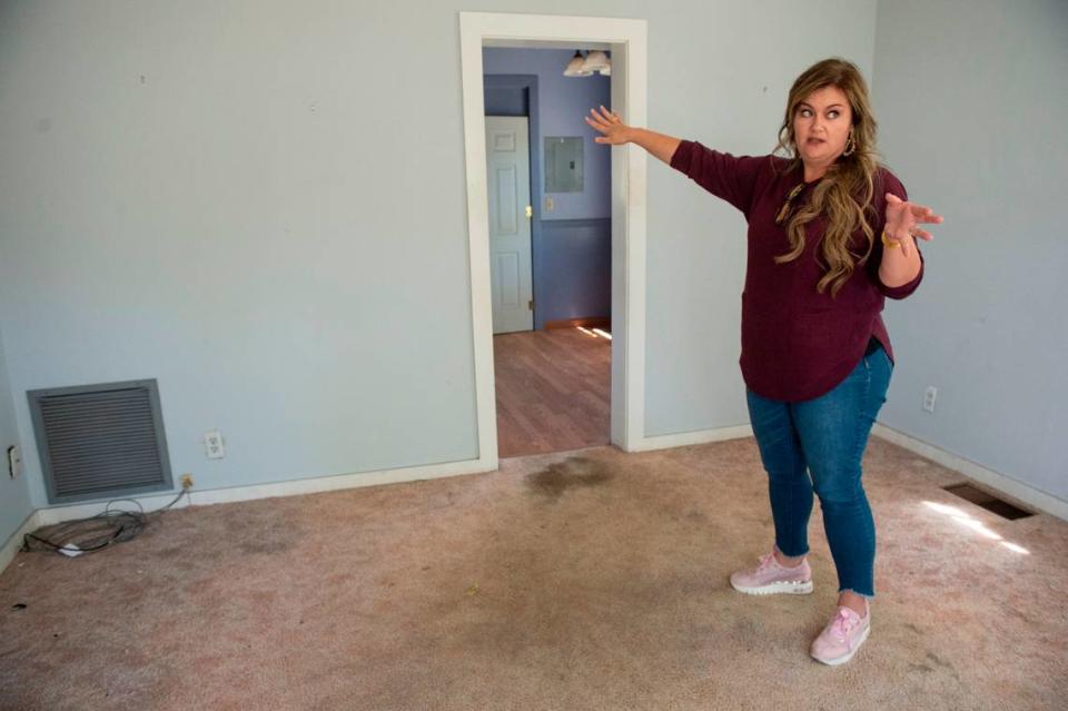 Michelle Hodges describes renovation plans as she stands in the living room at the Seven Gables house in Ocean Springs on Thursday, March 28, 2024.