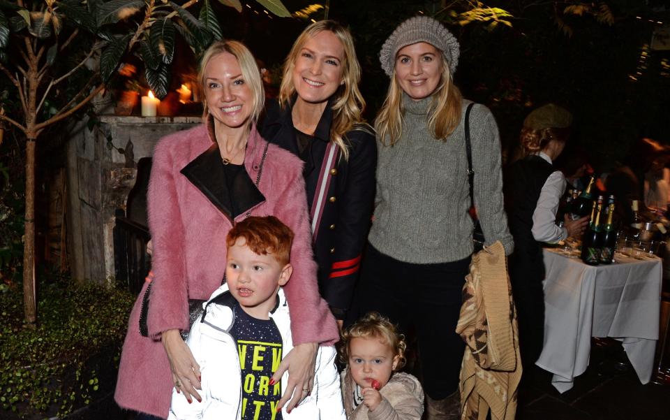 Rosie Nixon (left) with her son at the The Ivy Chelsea Garden's Guy Fawkes party in 2018