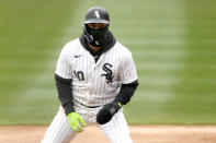 Chicago White Sox's Yoan Moncada wears a balaclava to keep the cold wind off his face as take a lead off from first during the first inning of a baseball game against the Atlanta Braves Monday, April 1, 2024, in Chicago. (AP Photo/Charles Rex Arbogast)
