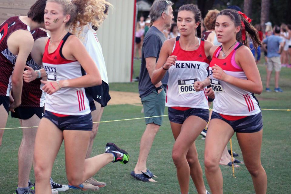 Bishop Kenny's Davis Johnson (6067), Alexis Holmes (6063) and Stephanie Grden (6062) run during the girls elite race in the Katie Caples Invitational. The Crusaders won their home meet for the first time since 2000.