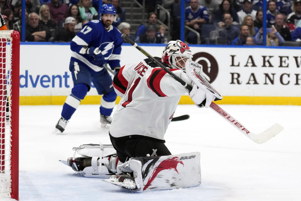 New Jersey Devils goaltender Vitek Vanecek (41) makes a blocker save on a shot by the Tampa Bay Lightning during the.second period of an NHL hockey game Sunday, March 19, 2023, in Tampa, Fla. (AP Photo/Chris O'Meara)