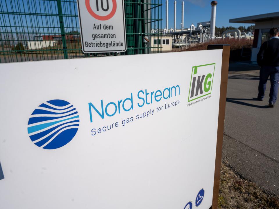 A sign with the words "Nord Stream" stands in front of the gas receiving station of the Nord Stream 1 Baltic Sea pipeline and the transfer station of the OPAL long-distance gas pipeline.