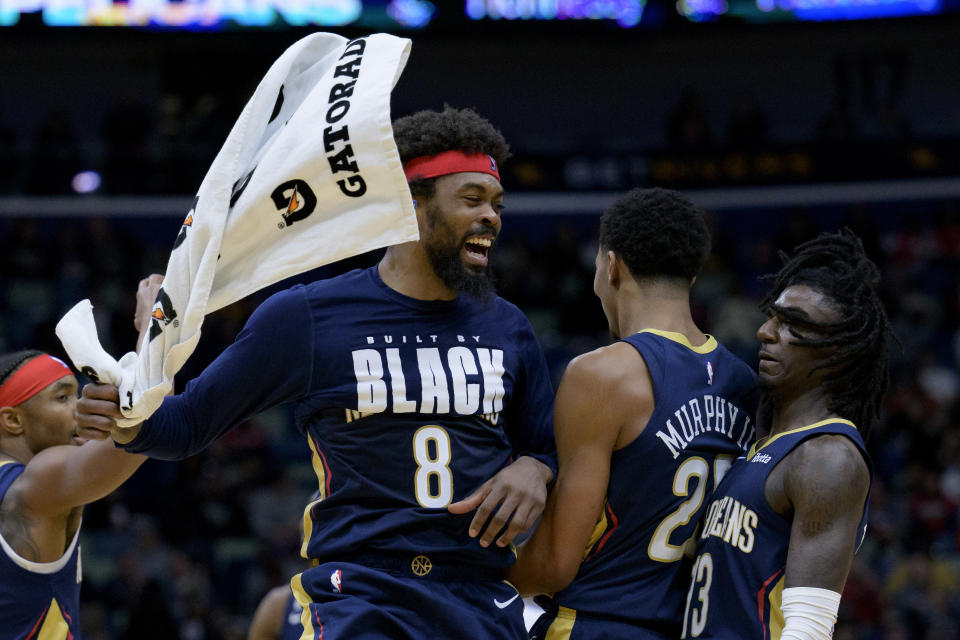 New Orleans Pelicans forward Naji Marshall (8) celebrates a dunk by guard Trey Murphy III next to guard Kira Lewis Jr. (13) in the first half of an NBA basketball game against the Sacramento Kings in New Orleans, Sunday, Feb. 5, 2023. (AP Photo/Matthew Hinton)