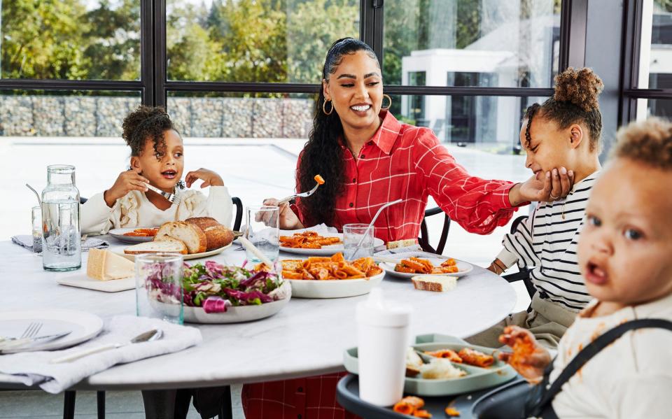 Ayesha Curry enjoys a meal with her children: Ryan, far left, Riley and Canon.