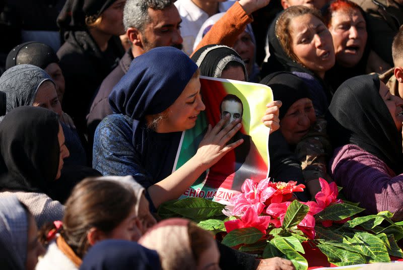 Women mourn during a funeral procession in Derik countryside