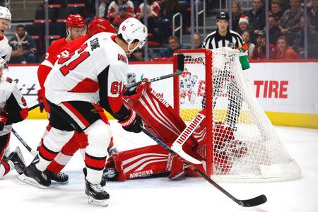 Dec 14, 2018; Detroit, MI, USA; Detroit Red Wings goaltender Jimmy Howard (35) makes the save on Ottawa Senators right wing Mark Stone (61) in the first period at Little Caesars Arena. Mandatory Credit: Rick Osentoski-USA TODAY Sports