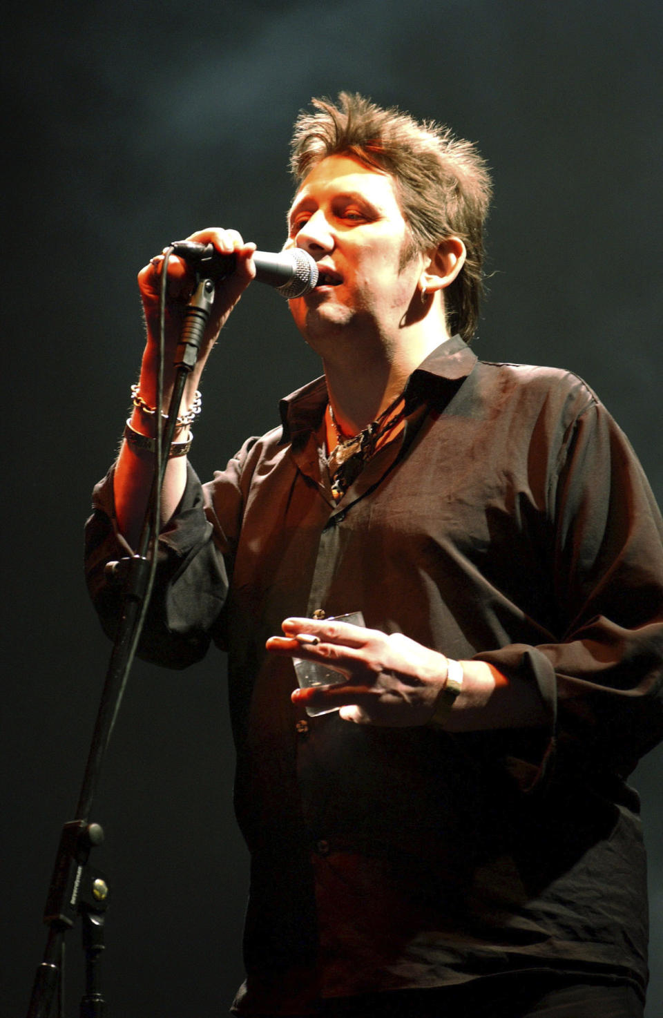 FILE - Shane McGowan performs live on stage at the Fleadh 2002 Music festival, Finsbury Park, North London, June 8, 2002. Macgowan, the singer-songwriter and frontman of The Pogues, best known for their ballad “Fairytale of New York,” has died. He was 65. His family said in a statement that "it is with the deepest sorrow and heaviest of hearts that we announce the passing of our most beautiful, darling and dearly beloved Shane Macgowan.” The singer died peacefully early Thursday, Nov. 30, 2023 with his family by his side, the statement added. (Andy Butterton/PA via AP, File)