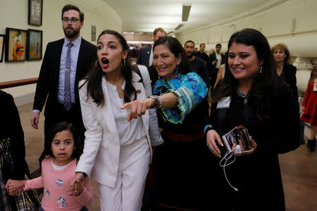 U.S. Representative Deb Haaland (D-NM) (2nd R) is joined by U.S. Representative Alexandria Ocasio-Cortez (D-NY) (2nd L) after they were sworn to the U.S. House of Representatives in Washington, U.S., January 3, 2019. REUTERS/Brian Snyder