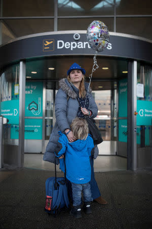 Sonja Morgenstern poses for a photograph with her son Mio, outside the departure entrance at Stansted Airport, London, Britain February 21, 2019. REUTERS/Simon Dawson