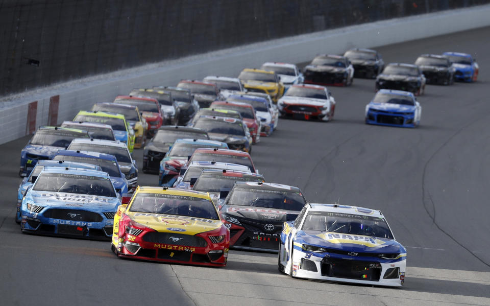 Chase Elliott (9) leads the field through the first turn at a NASCAR Cup Series auto race at Michigan International Speedway, Monday, June 10, 2019, in Brooklyn, Mich. (AP Photo/Carlos Osorio)