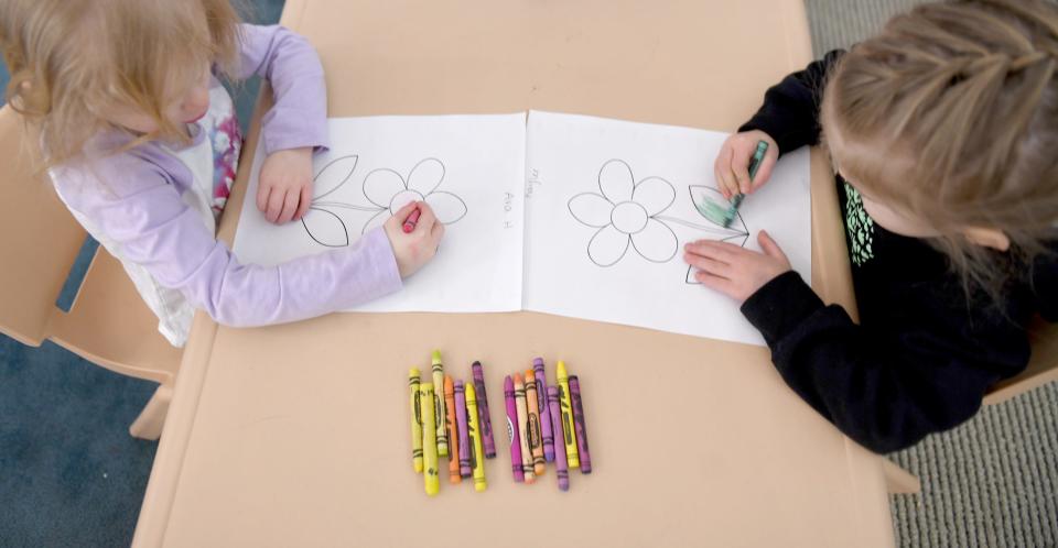 Ava Hansen (left) and Kaylee Hahn, both 3 years old, color a picture on Tuesday at Little Sprouts Daycare & Preschool in Massillon.