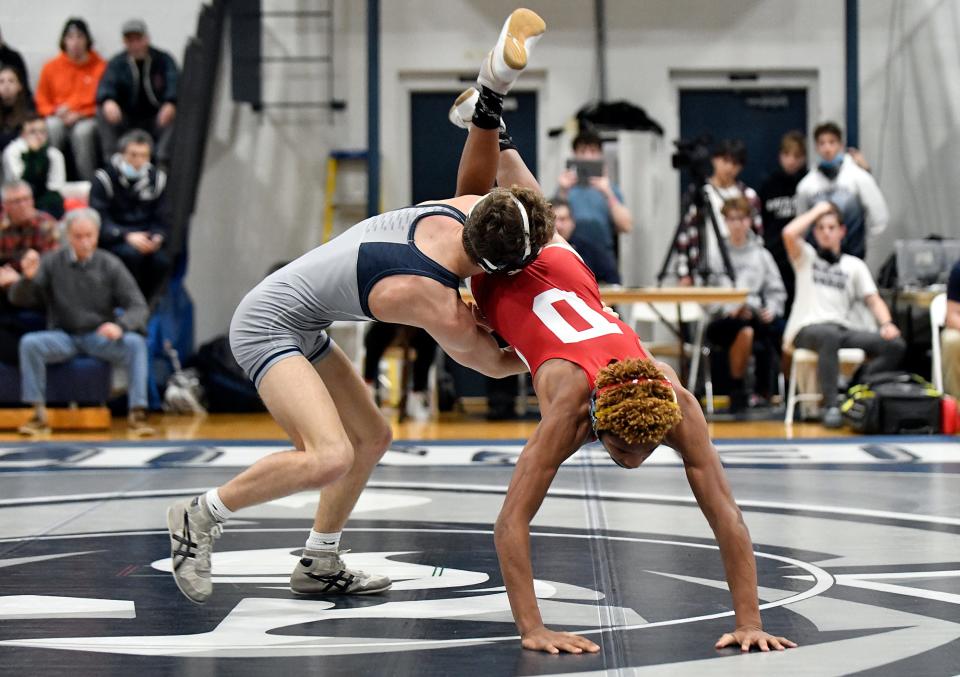 St. Augustine's Kaden Naame, left, takes down Delsea's Zavier Stokes during the 113 lb. wrestling bout in Richland on Thursday night. Naame defeated Stokes, 5-1, and the Hermits defeated Delsea, 31-28. Feb. 3, 2022.