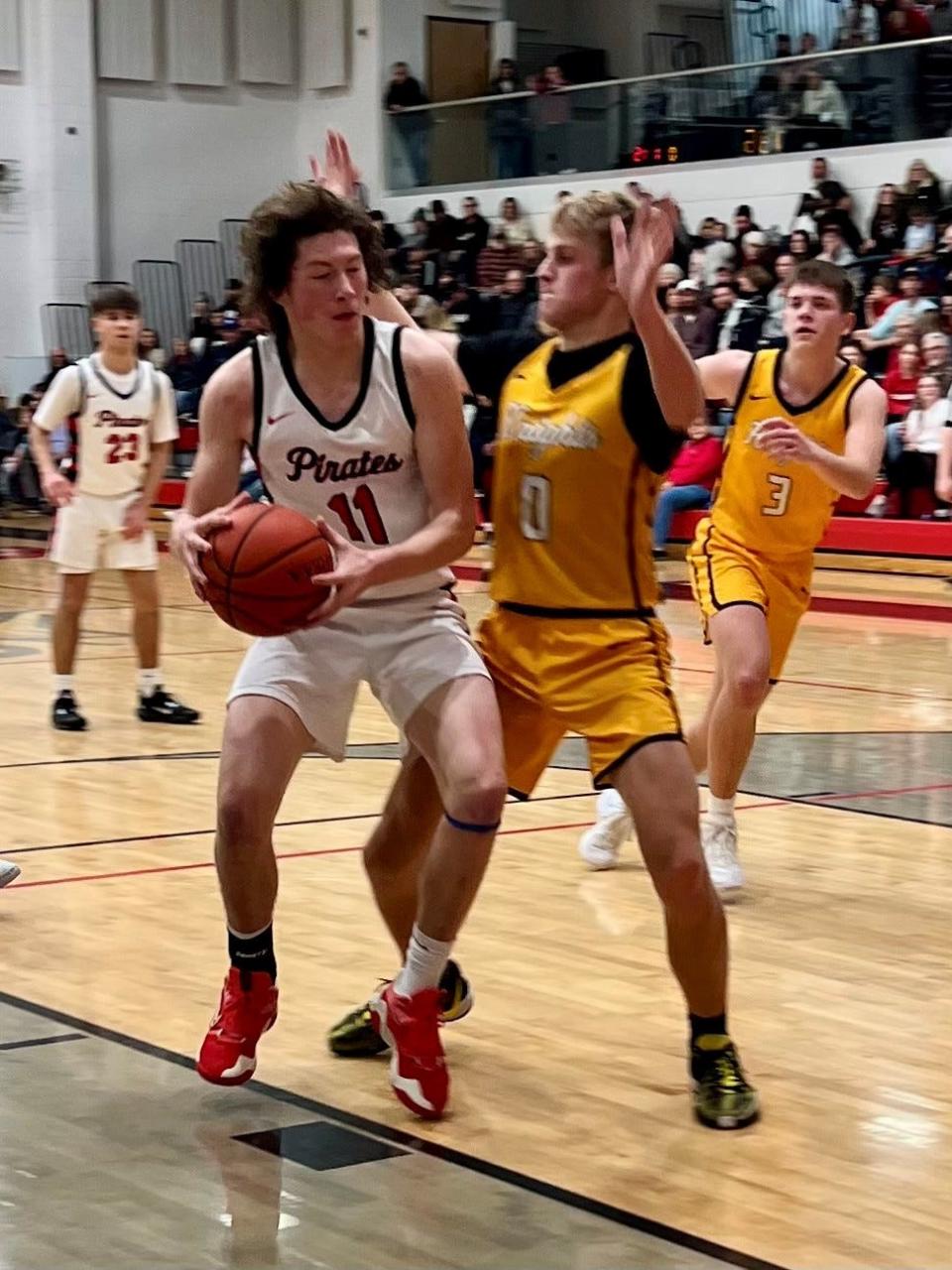 Cardington's Merek McClure works against Northmor's Grant Bentley on the block during a boys basketball game at Cardington Friday night.