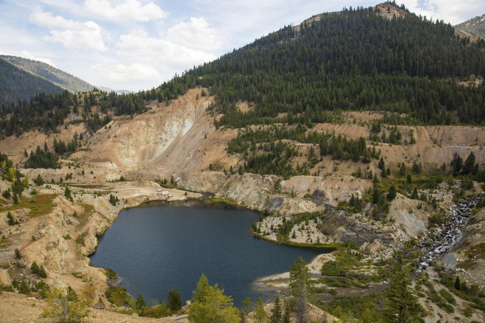 This Sept. 19, 2018 photo shows the Yellow Pine Pit open-pit gold mine in the Stibnite Mining District in central Idaho, where a company hopes to start mining again. Documents show the Trump administration intervening in a U.S. Forest Service decision so that a Canadian company could write a key environmental report on its proposed open-pit gold mines in central Idaho. (Riley Bunch/Idaho Press-Tribune via AP)