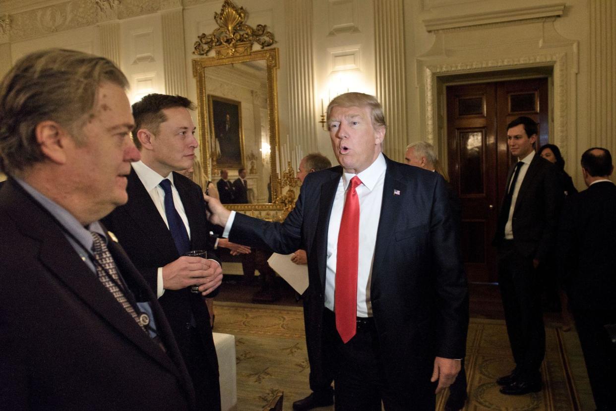 Trump advisor Steve Bannon (L) watches as US President Donald Trump greets Elon Musk, SpaceX and Tesla CEO, before a policy and strategy forum with executives in the State Dining Room of the White House: BRENDAN SMIALOWSKI/AFP via Getty Images