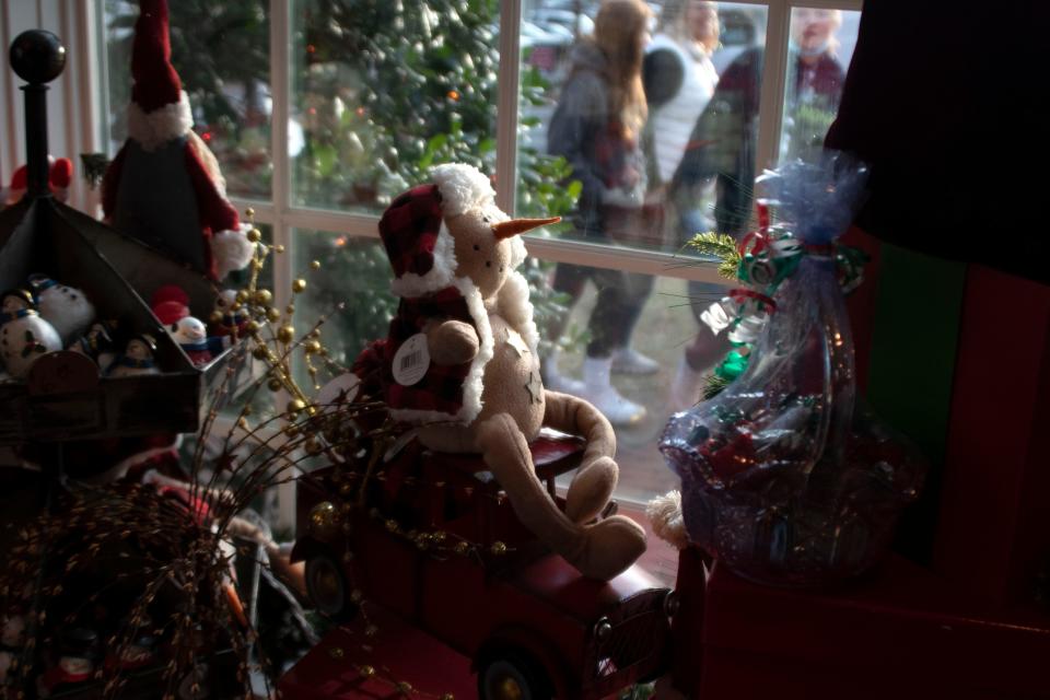 Visitors browse through Peddler's Village in Lahaska on Wednesday, Dec. 1, 2021. Visit the village this weekend for Fire & Frost Fun, featuring ice carvings, fire pits and more.