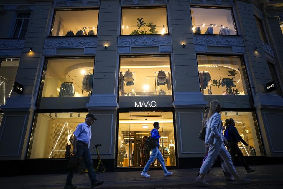 FILE - People walk past a newly opened Maag store, a former Zara flagship store, in Moscow, Russia, Monday, Aug. 21, 2023. The economy's resilience in the face of bruising Western sanctions is a major factor behind President Vladimir Putin's grip on power in Russia. (AP Photo/Alexander Zemlianichenko, File)