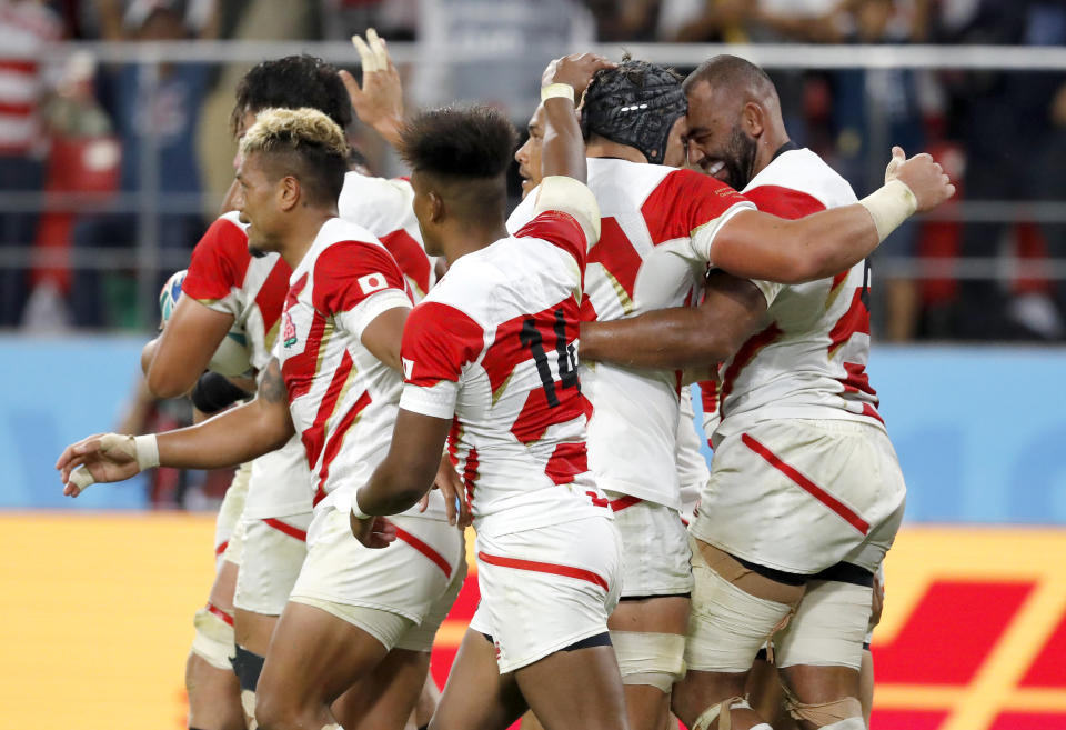 Japan players celebrate after a try by teammate Kazuki Himeno during the Rugby World Cup Pool A game at City of Toyota Stadium between Japan and Samoa in Tokyo City, Japan, Saturday, Oct. 5, 2019. (AP Photo/Shuji Kajiyama)