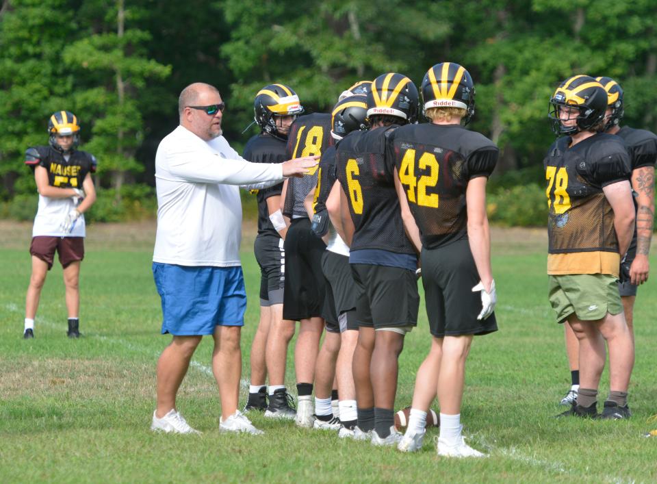 NORTH EASTHAM -- 08/29/22 -- First-year head coach Jesse Peno works with his players during practice Monday morning. 
Nauset Regional High School football is back in action. A practice was held Monday morning.