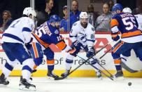 New York Islanders right wing Cal Clutterbuck (15) and Tampa Bay Lightning right wing Nikita Kucherov (86) battle for the puck during the third period in game three of the second round of the 2016 Stanley Cup Playoffs at Barclays Center. Mandatory Credit: Anthony Gruppuso-USA TODAY Sports