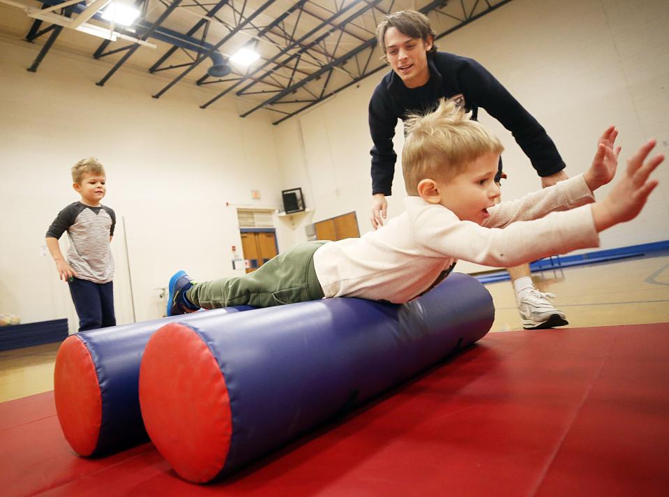 General instructor Max DeBord helps Archer Smith, 4, work on his Superman flying technique on Nov. 17 during the Superhero Training Academy portion of the Superhero Spectacular program at the Worthington Community Center. The Parks & Recreation Department is asking residents to take a survey to help shape future programming.