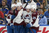 Colorado Avalanche's Logan O'Connor (25) is congratulated by teammates after scoring during the first period in Game 3 of an NHL hockey Stanley Cup second-round playoff series against the St. Louis Blues Saturday, May 21, 2022, in St. Louis. (AP Photo/Jeff Roberson)