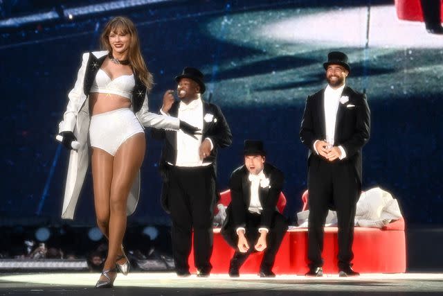 <p>Gareth Cattermole/TAS24/Getty Images</p> Travis Kelce onstage with Taylor Swift during her Eras Tour in London on June 23, 2024