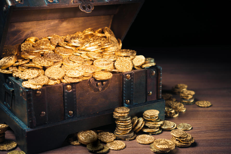 Open treasure chest filled with gold coins / HIgh contrast image