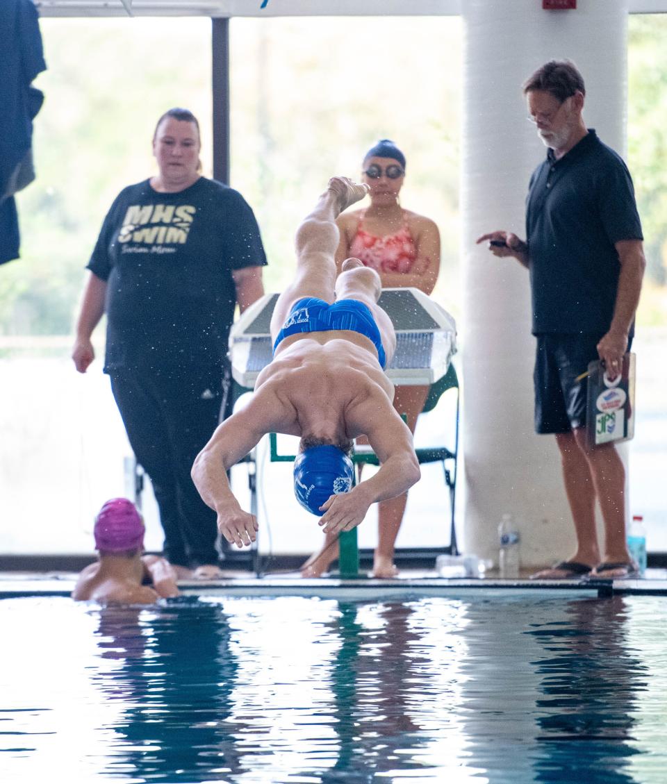 Logan Robinson, of Booker T. Washington High School, competes in the Boys 100 Yard Butterfly during the 3A District 1 Championship swim meet at the University of West Florida in Pensacola on Friday, Oct. 27, 2023.