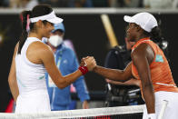 Emma Raducanu, left, of Britain is congratulated by Sloane Stephens of the U.S. after winning their first round match at the Australian Open tennis championships in Melbourne, Australia, Tuesday, Jan. 18, 2022. (AP Photo/Tertius Pickard)