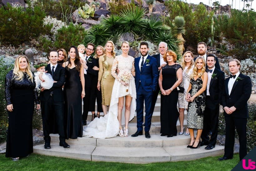 Whitney and Tim pose with their families.