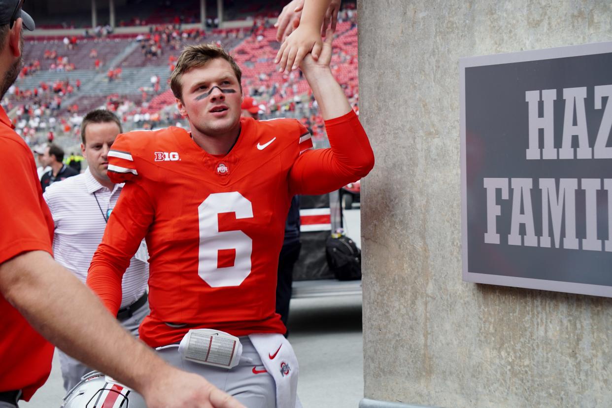 Ohio State quarterback Kyle McCord is congratulated by fans as he runs off the field following the Buckeyes' 35-7 win over Youngstown State on Sept. 9, 2023.