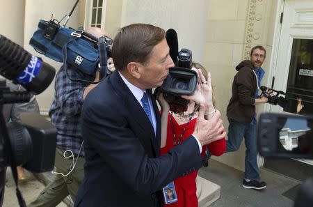 Former CIA director David Petraeus pushes aside a television videographer as he arrives at the Federal Courthouse in Charlotte, North Carolina April 23, 2015. REUTERS/Chris Keane