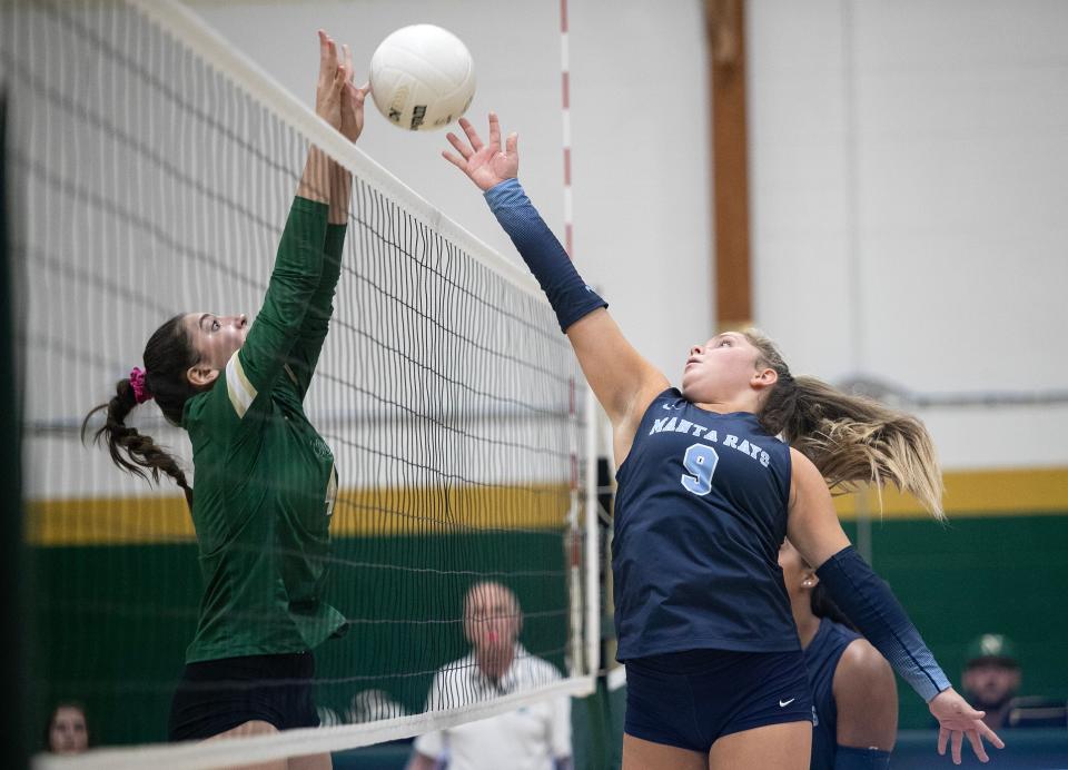 Madison Stolinas of Marco Island Academy tips the ball as Giuliana Batelli goes up for a block in the Class 2A Volleyball Regional Quarterfinals on Tuesday, Oct. 24, 2023, in Naples. Marco Island Academy won 3-1.