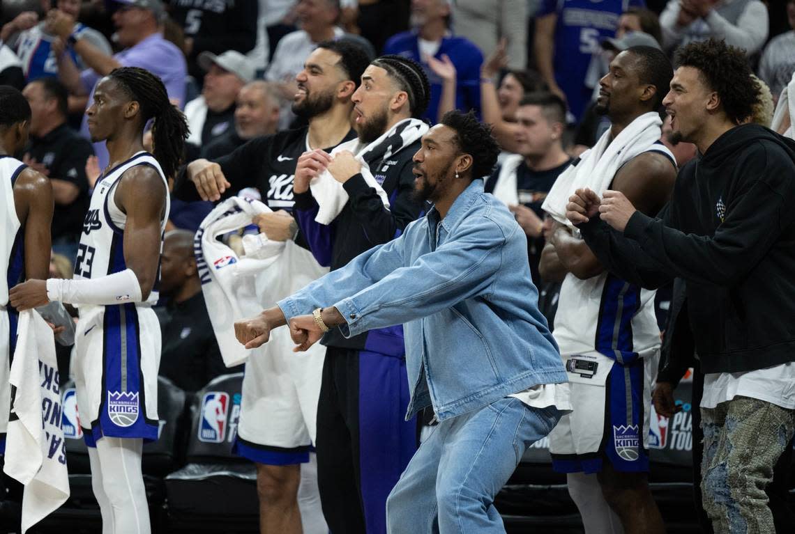 The Sacramento Kings bench, including injured Malik Monk, reacts during the final minute of the NBA play-in game against the Golden State Warriors at Golden 1 Center on Tuesday.