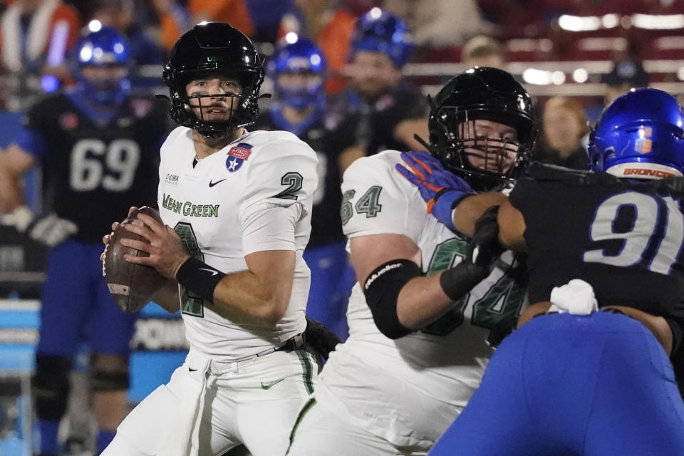 North Texas quarterback Austin Aune (2) looks to pass with blocking from offensive lineman Jett Duncan (64) against Boise State defensive tackle Ahmed Hassanein (91) during the first quarter of the Frisco Bowl NCAA college football game Saturday, Dec. 17, 2022, in Frisco, Texas. (AP Photo/LM Otero)