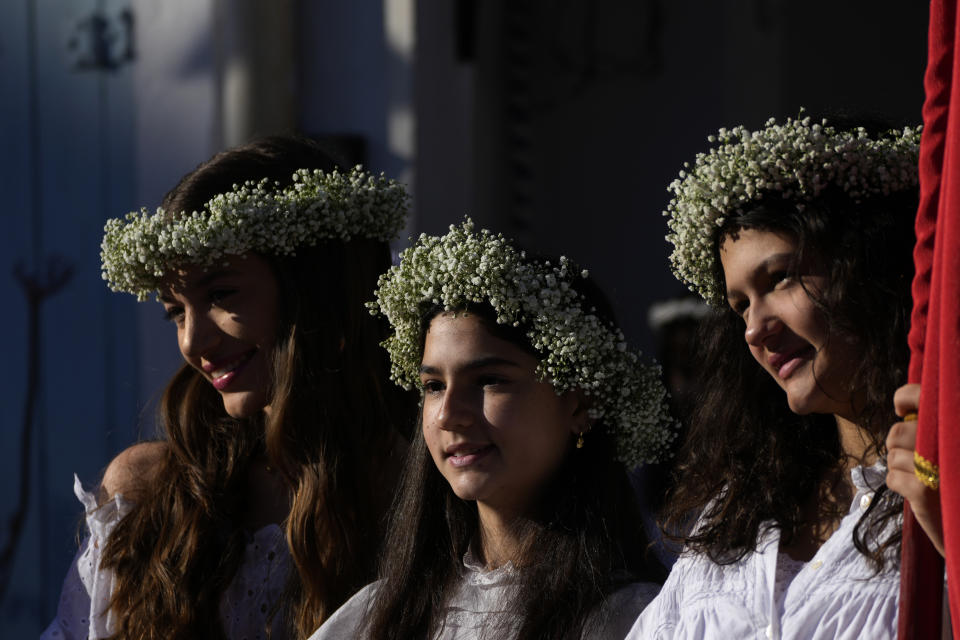 Girls take part in the Cavalhadas festival in Pirenopolis, Goias, Brazil, Sunday, May 19, 2024. A Portuguese priest brought the tradition to Brazil in the 1800s to celebrate the Holy Spirit and to commemorate the victory of Iberian Christian knights over the Moors. (AP Photo/Eraldo Peres)