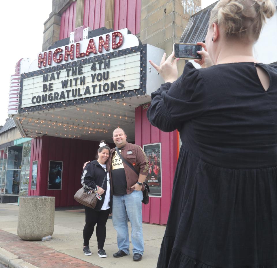 Newlyweds Julie Samuels and Jared Bernstein of Beachwood are photographed by Nicole Hagy, community outreach coordinator for the Akron Municipal Court, in front of the Highland Theater after their Star Wars-themed wedding Wednesday in Akron.