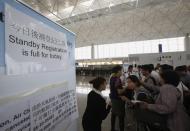 Passengers wait for their departure at Hong Kong Airport after Typhoon Usagi, the strongest storm to hit the Western Pacific this year, swiped Hong Kong September 23, 2013. A powerful typhoon hit Hong Kong and the southern China coast on Monday, killing at least 20 people on the mainland, crippling power lines and causing flooding and gale force winds. More than 370 flights were cancelled. REUTERS/Bobby Yip