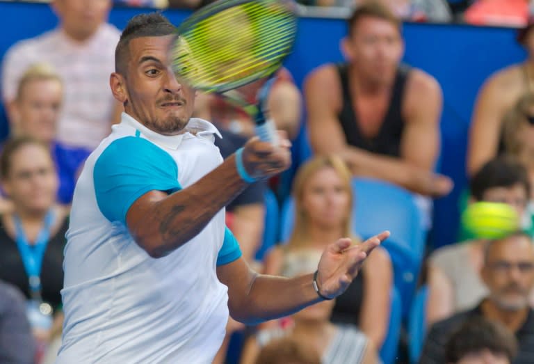 Nick Kyrgios of the Australian Green team hits a return against Andy Murray of Britain during their eighth session men's singles match on day four of the Hopman Cup tournament, in Perth, on January 6, 2016