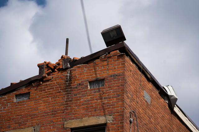 Mar 27, 2023; Columbus, Ohio, USA;  A combination commercial and residential building on the corner of Oak Street and Parsons Avenue, has been temporarily evacuated as a precaution, after high winds brought down the building's chimney and separated part of the roof from the building on Saturday. 