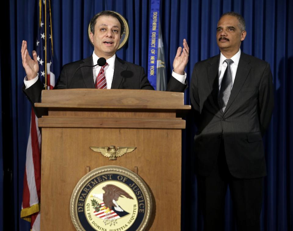 U.S. Attorney for the Southern District of New York Preet Bharara, left, speaks while U.S. Attorney General Eric Holder listens during a news conference in New York, Tuesday, April 1, 2014. Holder says the successful prosecution of Osama bin Laden's son-in-law in New York shows terror trials can be safely held in the United States.(AP Photo/Seth Wenig)