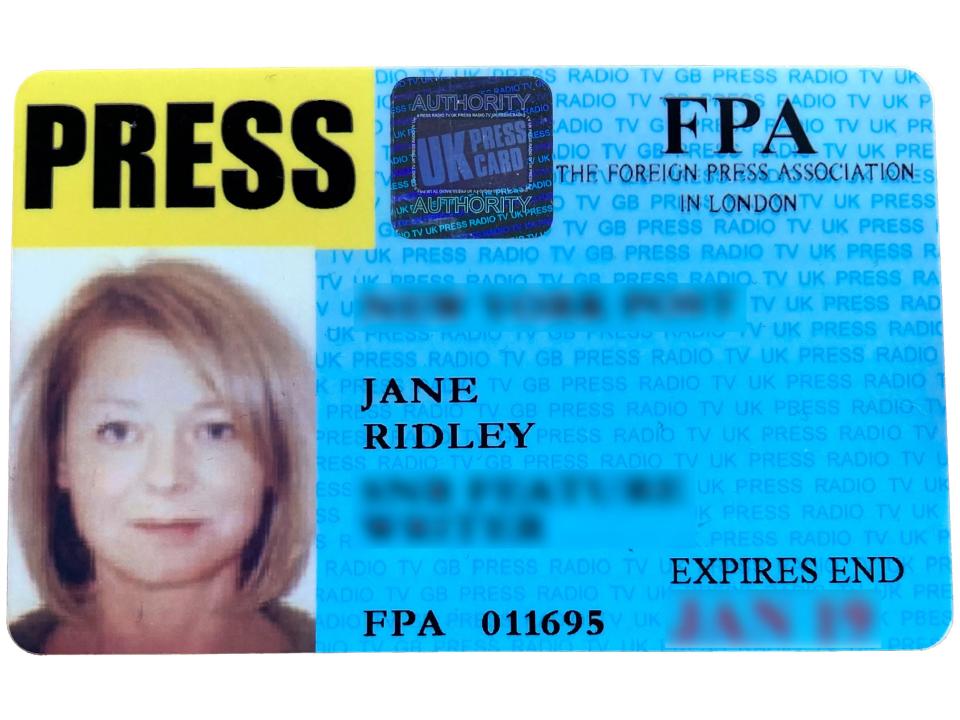 A press card showing a woman reporter