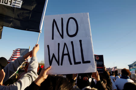 Demonstrators hold up signs as they take part in the 'March for Truth: Stop the Wall, Stop the Lies' during the visit of U.S. President Donald Trump to El Paso, Texas, U.S. February 11, 2019. REUTERS/Jose Luis Gonzalez