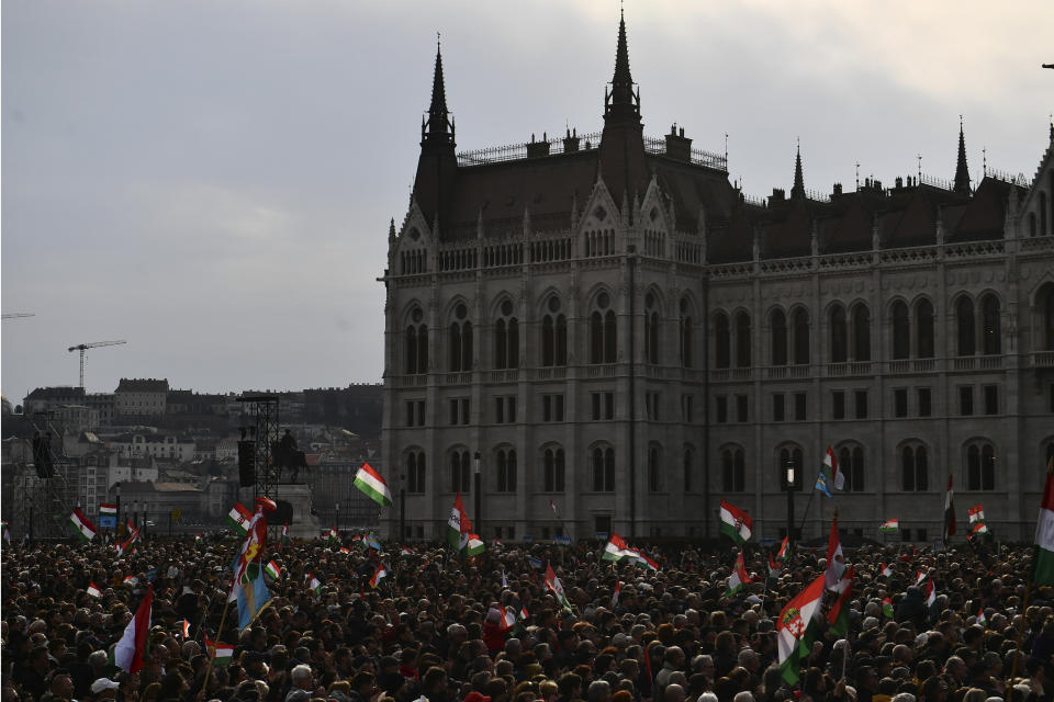 Thousands of supporters of Hungary's right-wing populist prime minister, Viktor Orban, gather near the Parliament building in Budapest, Hungary, Tuesday, March 15, 2022. The so-called "peace march" was a show of strength by Orban's supporters ahead of national elections scheduled for April 3, while a coalition of six opposition parties also held a rally in the capital. (AP Photo/Anna Szilagyi)