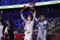 Members of Team Lebanon arrive during the opening ceremony in the Olympic Stadium at the 2020 Summer Olympics, Friday, July 23, 2021, in Tokyo, Japan. (Hannah McKay/Pool Photo via AP)