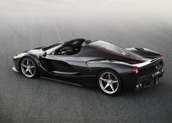 A black LaFerrari Aperta, a sleek, mid-engined ultra-high-performance sports car with an open roof.