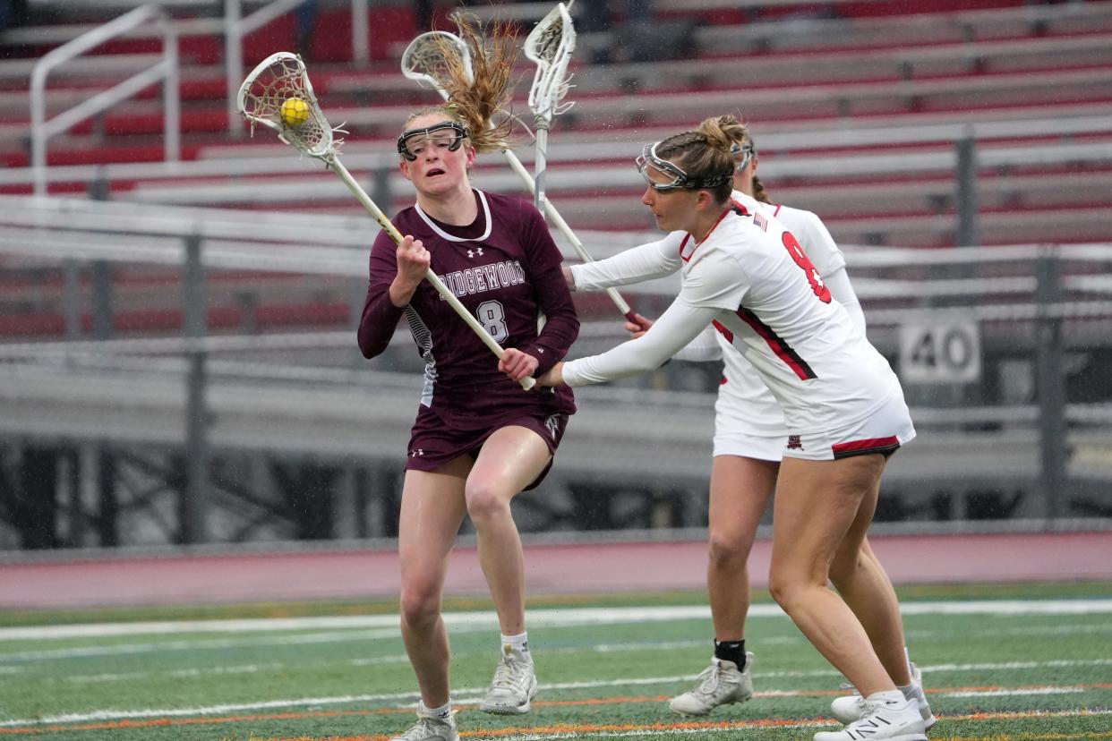 Grace Sullivan, of Ridgewood, tries to get by Emmy Campbell, of Northern Highlands, Tuesday, April 2, 2024, in Allendale.