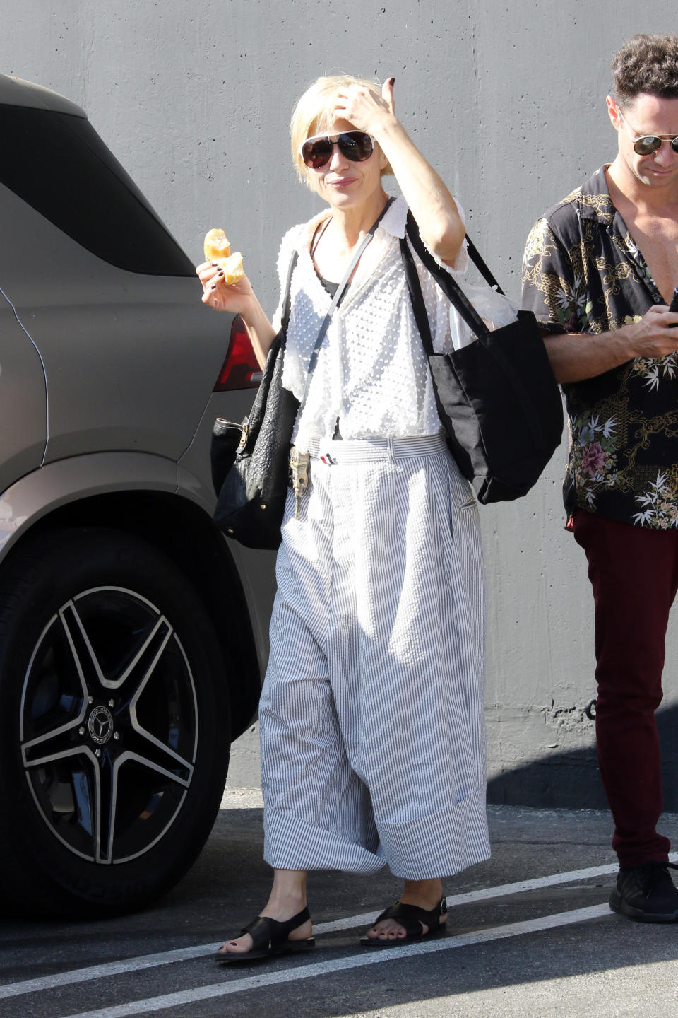 selma walking outside with a donut