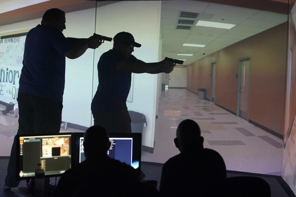 Utah teachers interact with a video simulator that creates an active shooter scenario in a school during a training session on September 25, 2019 in Provo, Utah. / Credit: George Frey / Getty Images